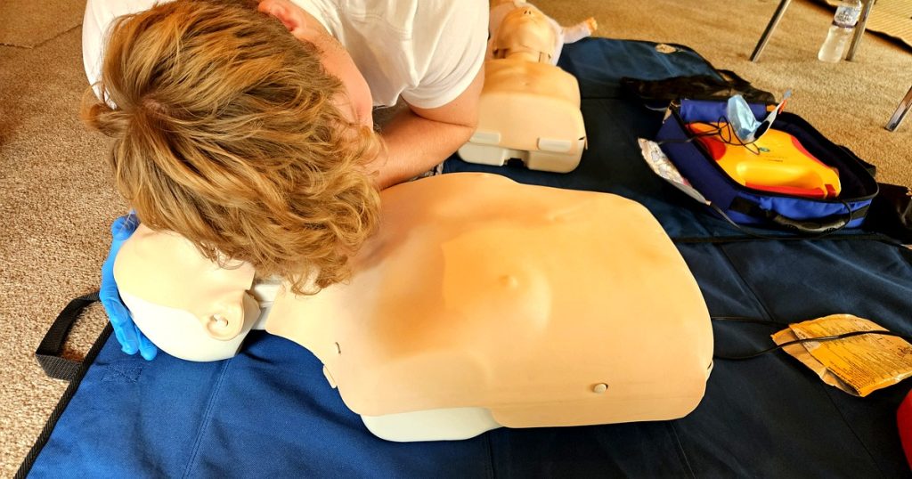 First aid training Suffolk - NHS paramedic instructor delivering on-site course