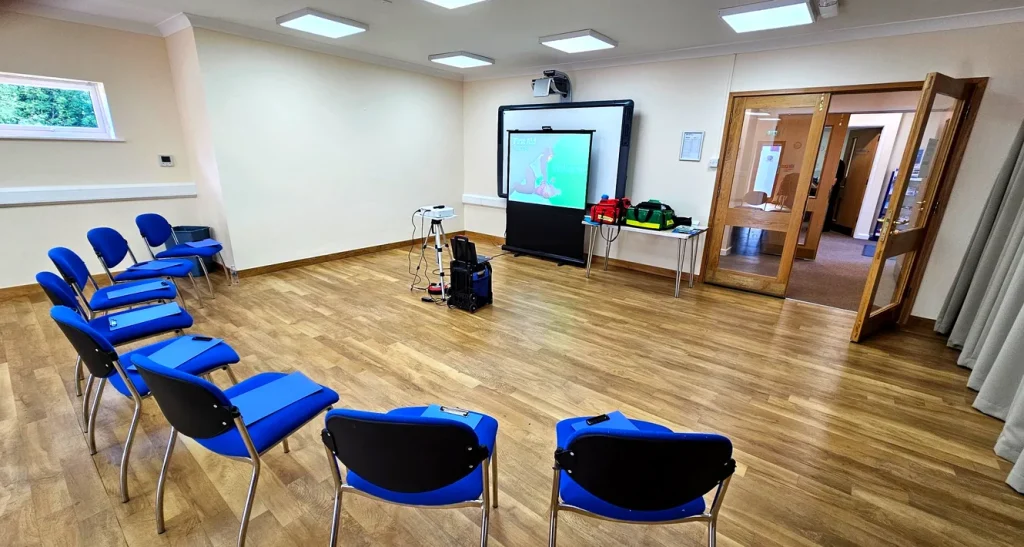 First aid training classroom set up in Ely with presentation screen and emergency equipment