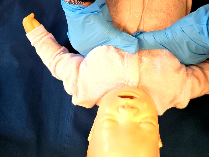 Paediatric first aid training Lowestoft – infant CPR practice on baby mannequin