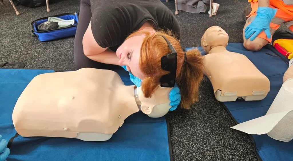 First aid instructor Peterborough – NHS paramedic demonstrating CPR and AED use during workplace training course